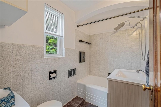 142 Slater Dr, Pleasant Hills, PA 15236 - bathroom featuring tile walls, vanity, toilet, shower / washtub combination, and a wainscoted wall