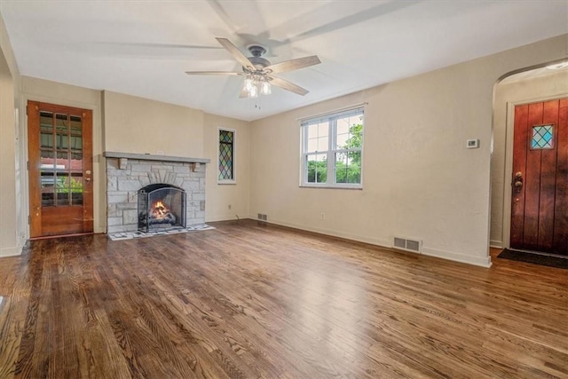 142 Slater Dr, Pleasant Hills, PA 15236 - unfurnished living room with wood finished floors, ceiling fan, a stone fireplace, and baseboards