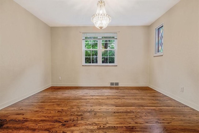 142 Slater Dr, Pleasant Hills, PA 15236 - empty room featuring a chandelier, wood finished floors, and baseboards