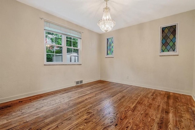 142 Slater Dr, Pleasant Hills, PA 15236 - unfurnished room with a chandelier, wood finished floors, and baseboards
