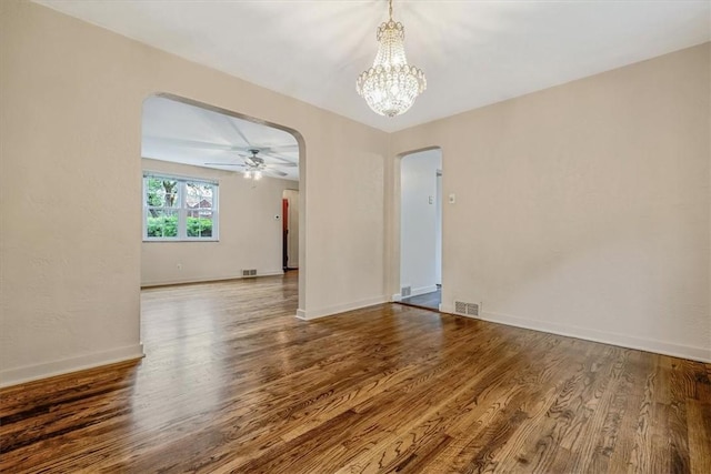 142 Slater Dr, Pleasant Hills, PA 15236 - empty room featuring arched walkways, wood finished floors, a chandelier, baseboards, and ceiling fan
