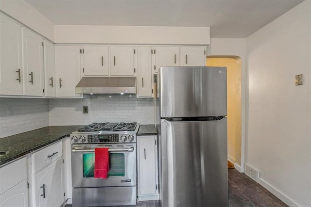 142 Slater Dr, Pleasant Hills, PA 15236 - kitchen featuring stainless steel appliances, under cabinet range hood, white cabinetry, backsplash, and dark stone countertops