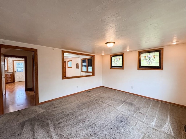 2701 Lafayette St, Mckeesport, PA 15132 - spare room featuring dark colored carpet, baseboards, and a textured ceiling