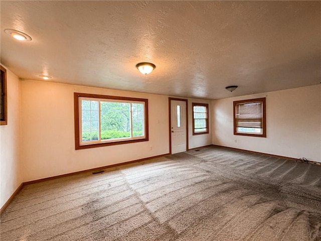 2701 Lafayette St, Mckeesport, PA 15132 - empty room with carpet floors, baseboards, and a textured ceiling