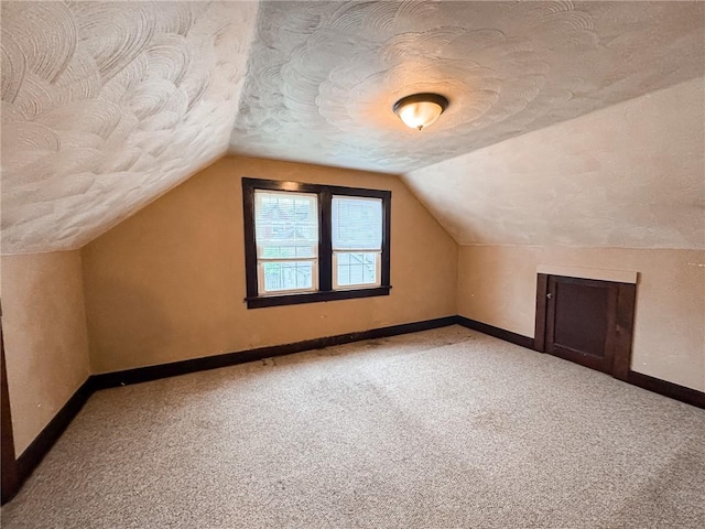 2701 Lafayette St, Mckeesport, PA 15132 - additional living space with baseboards, a textured ceiling, carpet, and lofted ceiling