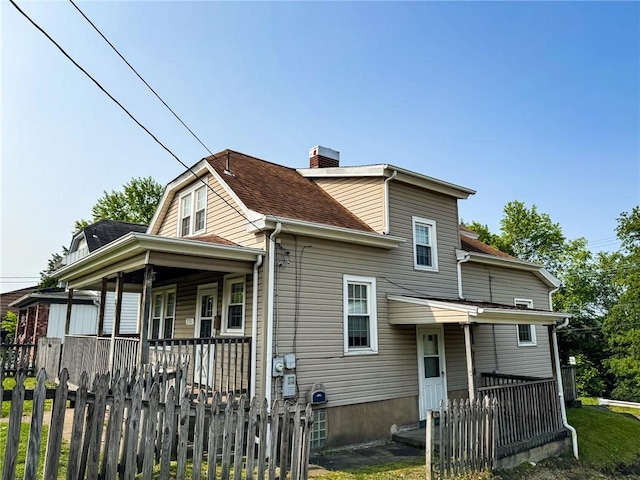 2701 Lafayette St, Mckeesport, PA 15132 - rear view of property featuring a chimney, covered porch, and a shingled roof