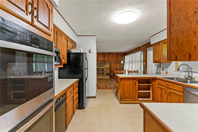 48 Green Crescent Dr, South Strabane, PA 15301 - kitchen featuring appliances with stainless steel finishes, a sink, light floors, a textured ceiling, and wooden walls