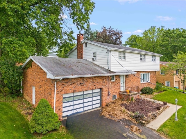 48 Green Crescent Dr, South Strabane, PA 15301 - view of front of home featuring brick siding, asphalt driveway, a chimney, a front lawn, and a shingled roof