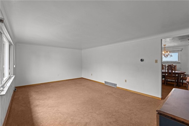 719 12th St, Pitcairn, PA 15140 - unfurnished living room featuring a chandelier, carpet floors, and baseboards
