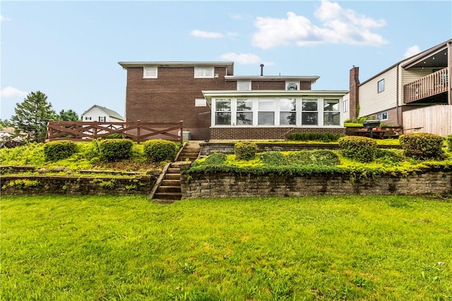 719 12th St, Pitcairn, PA 15140 - rear view of property featuring brick siding, stairway, and a yard