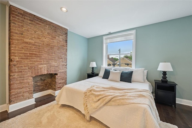 5822 Rippey St, East Liberty, PA 15206 - bedroom with baseboards, wood finished floors, a brick fireplace, and recessed lighting