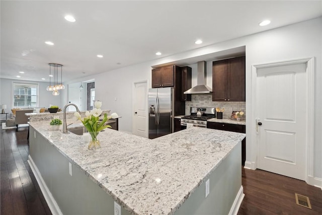 5822 Rippey St, East Liberty, PA 15206 - kitchen with wall chimney exhaust hood, appliances with stainless steel finishes, dark wood-style floors, a sink, and dark brown cabinets