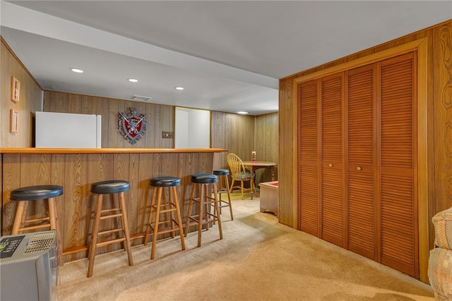 332 Division Ln, Vanport, PA 15009 - indoor dry bar featuring light colored carpet, wood walls, freestanding refrigerator, and recessed lighting