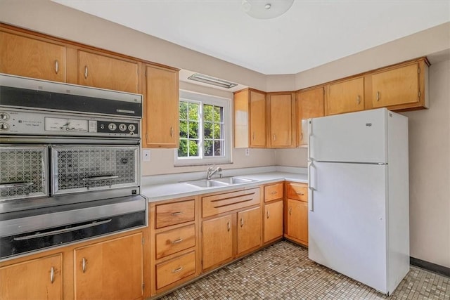 115 Norrington Dr, South Park, PA 15236 - kitchen with freestanding refrigerator, a sink, light countertops, and a warming drawer