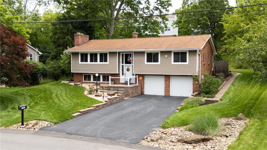 1941 Dubonnet Ct, Mccandless, PA 15101 - split foyer home featuring driveway, a chimney, brick siding, an attached garage, and a front lawn