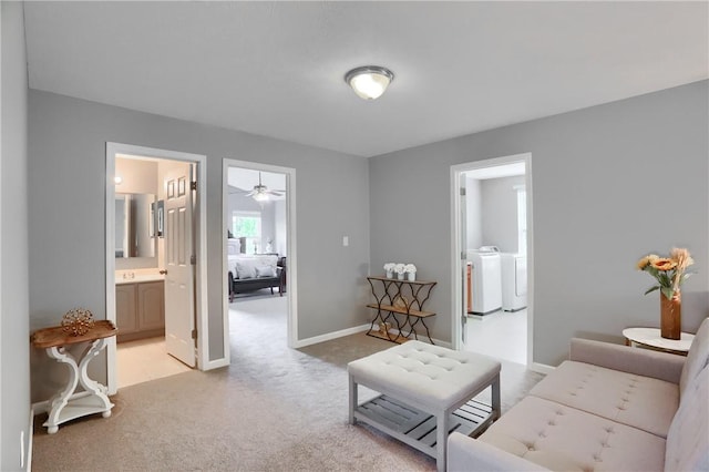 8014 Maureen Dr, Cranberry Twp, PA 16066 - living area featuring independent washer and dryer, light carpet, a ceiling fan, and baseboards