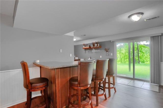 8014 Maureen Dr, Cranberry Twp, PA 16066 - indoor wet bar with light wood-style flooring and wainscoting