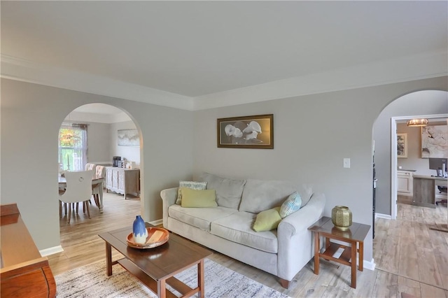 8014 Maureen Dr, Cranberry Twp, PA 16066 - living area featuring arched walkways, light wood-type flooring, and baseboards