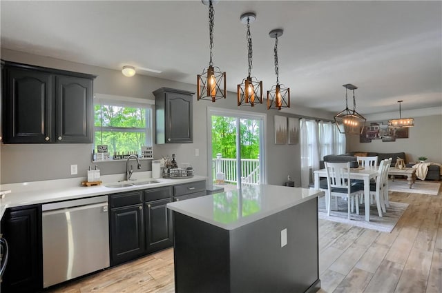 8014 Maureen Dr, Cranberry Twp, PA 16066 - kitchen featuring stainless steel dishwasher, a sink, light countertops, light wood finished floors, and decorative light fixtures