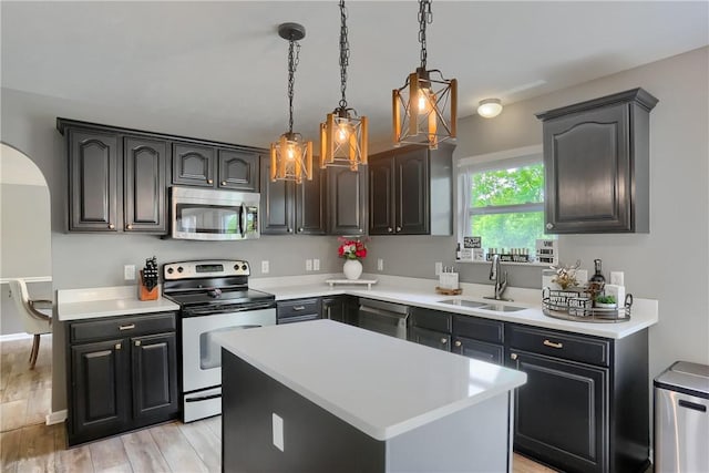 8014 Maureen Dr, Cranberry Twp, PA 16066 - kitchen with stainless steel appliances, a sink, light countertops, and pendant lighting