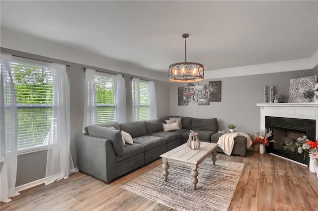 8014 Maureen Dr, Cranberry Twp, PA 16066 - living area with light wood-style flooring, a chandelier, and a fireplace