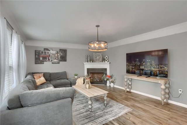 8014 Maureen Dr, Cranberry Twp, PA 16066 - living room featuring crown molding, wood finished floors, a chandelier, baseboards, and a fireplace