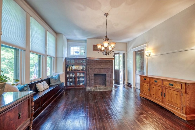 31 Nicholson St, Crafton, PA 15205 - living area with a chandelier, dark wood finished floors, and a brick fireplace