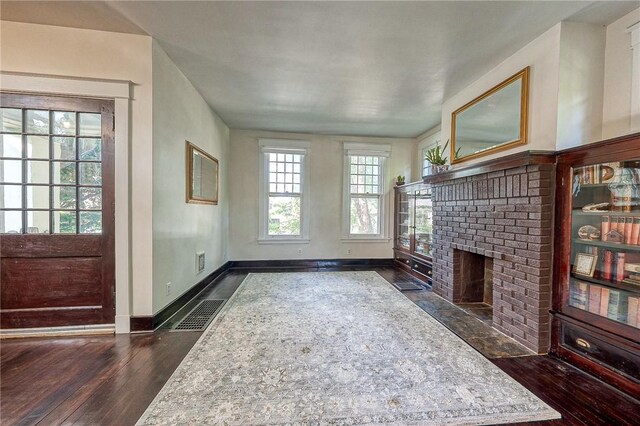 31 Nicholson St, Crafton, PA 15205 - unfurnished living room with a brick fireplace, baseboards, and dark wood-type flooring