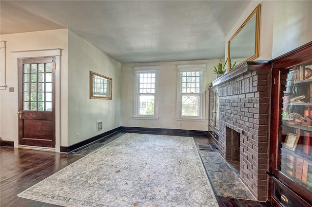 31 Nicholson St, Crafton, PA 15205 - unfurnished living room featuring baseboards, a brick fireplace, and dark wood finished floors