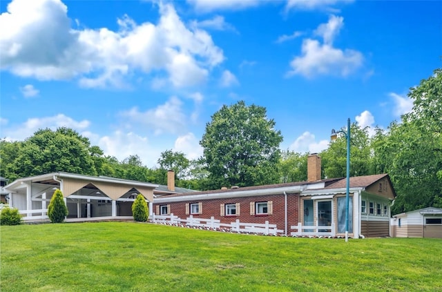 427 Harpers Ferry Rd, North Sewickley Twp, PA 15010 - view of front of home featuring a sunroom, a chimney, a front lawn, and brick siding