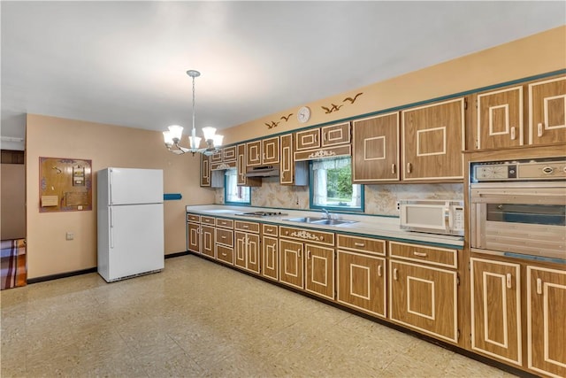 427 Harpers Ferry Rd, North Sewickley Twp, PA 15010 - kitchen with white appliances, a sink, under cabinet range hood, a chandelier, and baseboards
