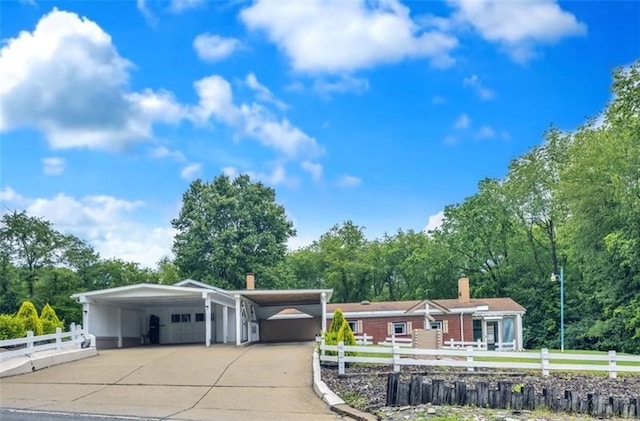 427 Harpers Ferry Rd, North Sewickley Twp, PA 15010 - ranch-style house featuring a chimney, a detached garage, and view of wooded area