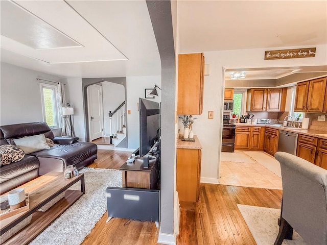 4330 Overhill St, Bethel Park, PA 15102 - living room with light wood finished floors, arched walkways, stairway, and baseboards