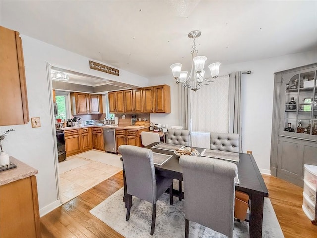4330 Overhill St, Bethel Park, PA 15102 - dining room with a chandelier, light wood-type flooring, and baseboards