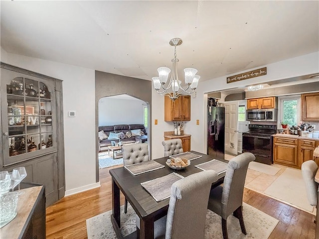 4330 Overhill St, Bethel Park, PA 15102 - dining area featuring arched walkways, a chandelier, and light wood-style floors