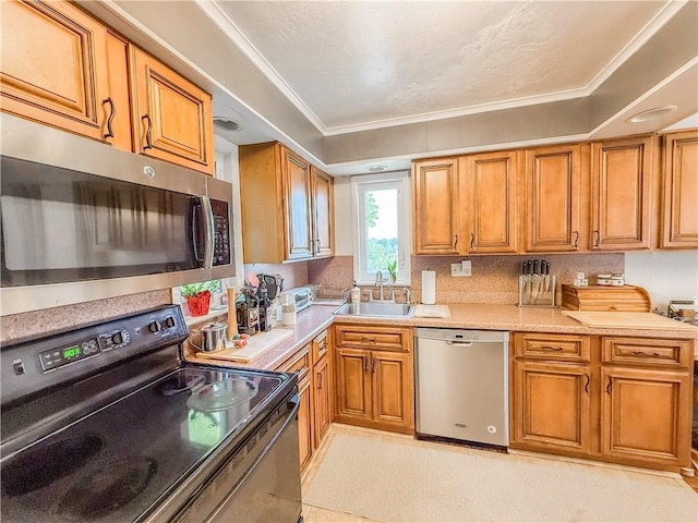4330 Overhill St, Bethel Park, PA 15102 - kitchen with stainless steel appliances, a sink, brown cabinetry, light countertops, and ornamental molding