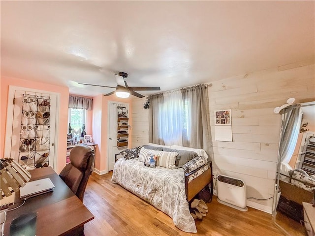 4330 Overhill St, Bethel Park, PA 15102 - bedroom with light wood-type flooring, ceiling fan, wooden walls, and a desk