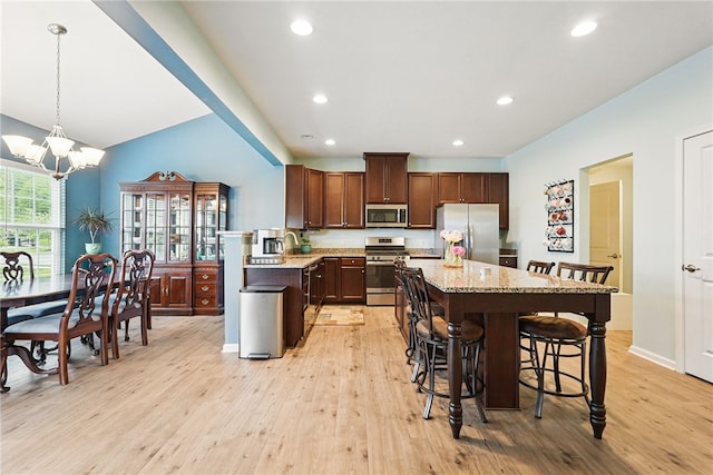 407 Isabella Ct, Zelienople Boro, PA 16063 - kitchen featuring appliances with stainless steel finishes, light wood finished floors, a kitchen breakfast bar, a center island, and recessed lighting