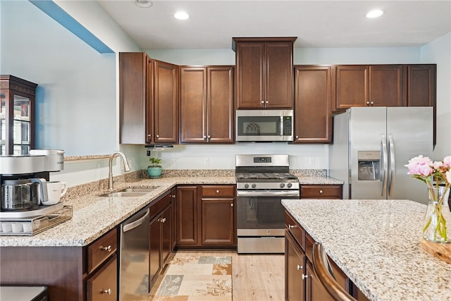 407 Isabella Ct, Zelienople Boro, PA 16063 - kitchen with stainless steel appliances, a sink, light stone counters, recessed lighting, and light wood-style flooring