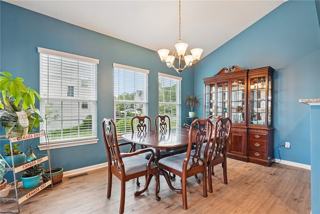 407 Isabella Ct, Zelienople Boro, PA 16063 - dining area featuring a chandelier, light wood finished floors, lofted ceiling, and baseboards
