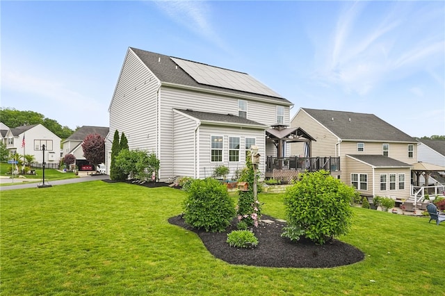 407 Isabella Ct, Zelienople Boro, PA 16063 - rear view of property with a gazebo, roof mounted solar panels, a lawn, and a deck