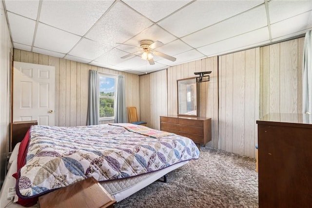 600 Scott St, Penn Twp Wml, PA 15675 - bedroom featuring a drop ceiling, carpet flooring, wood walls, and a ceiling fan