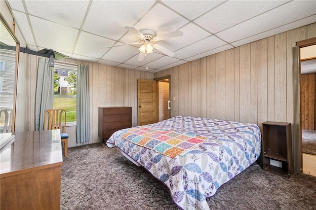 600 Scott St, Penn Twp Wml, PA 15675 - carpeted bedroom with wood walls, a paneled ceiling, and a ceiling fan