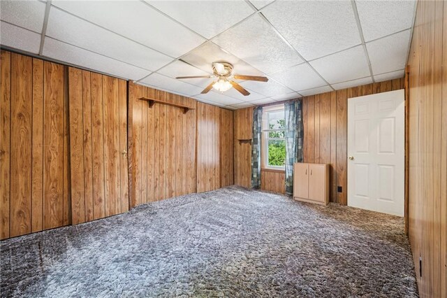 600 Scott St, Penn Twp Wml, PA 15675 - empty room featuring carpet flooring, wooden walls, a drop ceiling, and ceiling fan