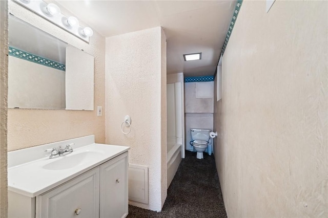 600 Scott St, Penn Twp Wml, PA 15675 - full bath featuring a textured wall, vanity, toilet, and shower / bath combination