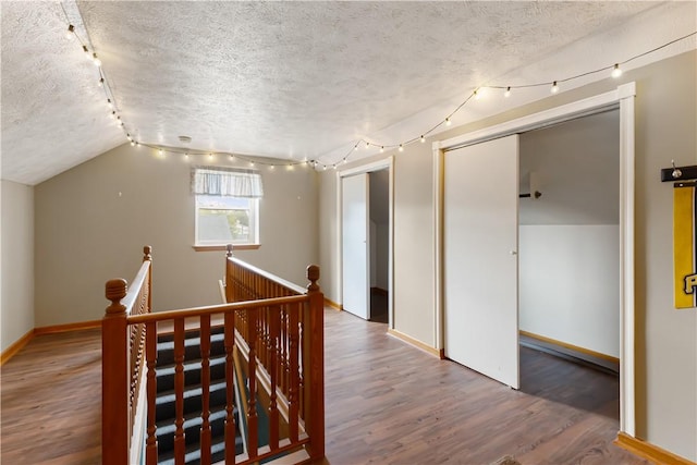 5 Beach St, Centerville, PA 15358 - hallway featuring an upstairs landing, a textured ceiling, wood finished floors, vaulted ceiling, and baseboards