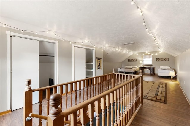 5 Beach St, Centerville, PA 15358 - hallway with track lighting, wood finished floors, lofted ceiling, a textured ceiling, and an upstairs landing