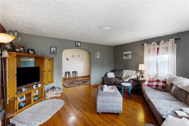 5 Beach St, Centerville, PA 15358 - living room with arched walkways, wood finished floors, a textured ceiling, and baseboards