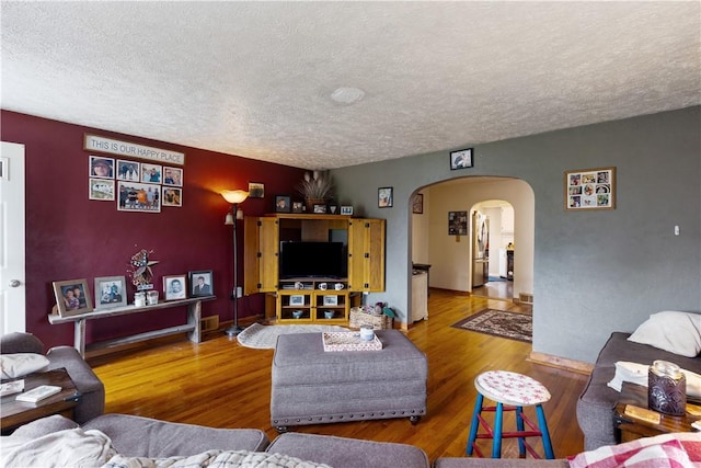 5 Beach St, Centerville, PA 15358 - living area featuring a textured ceiling, arched walkways, and wood finished floors