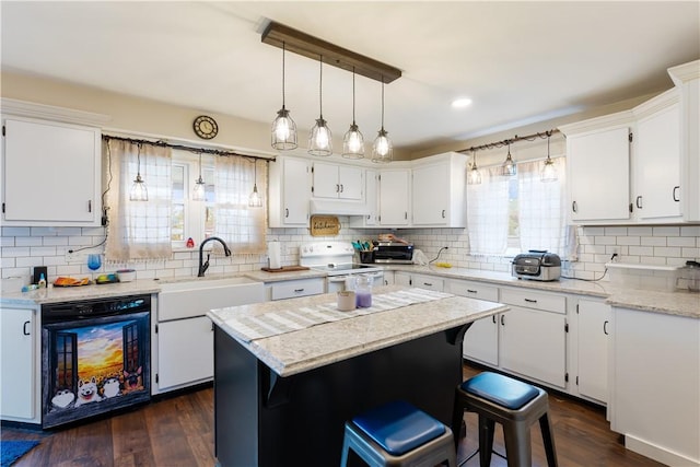 5 Beach St, Centerville, PA 15358 - kitchen with white range with electric stovetop, a sink, backsplash, under cabinet range hood, and white cabinetry